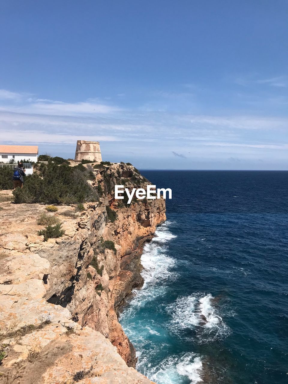 ROCK FORMATIONS ON SEA AGAINST SKY