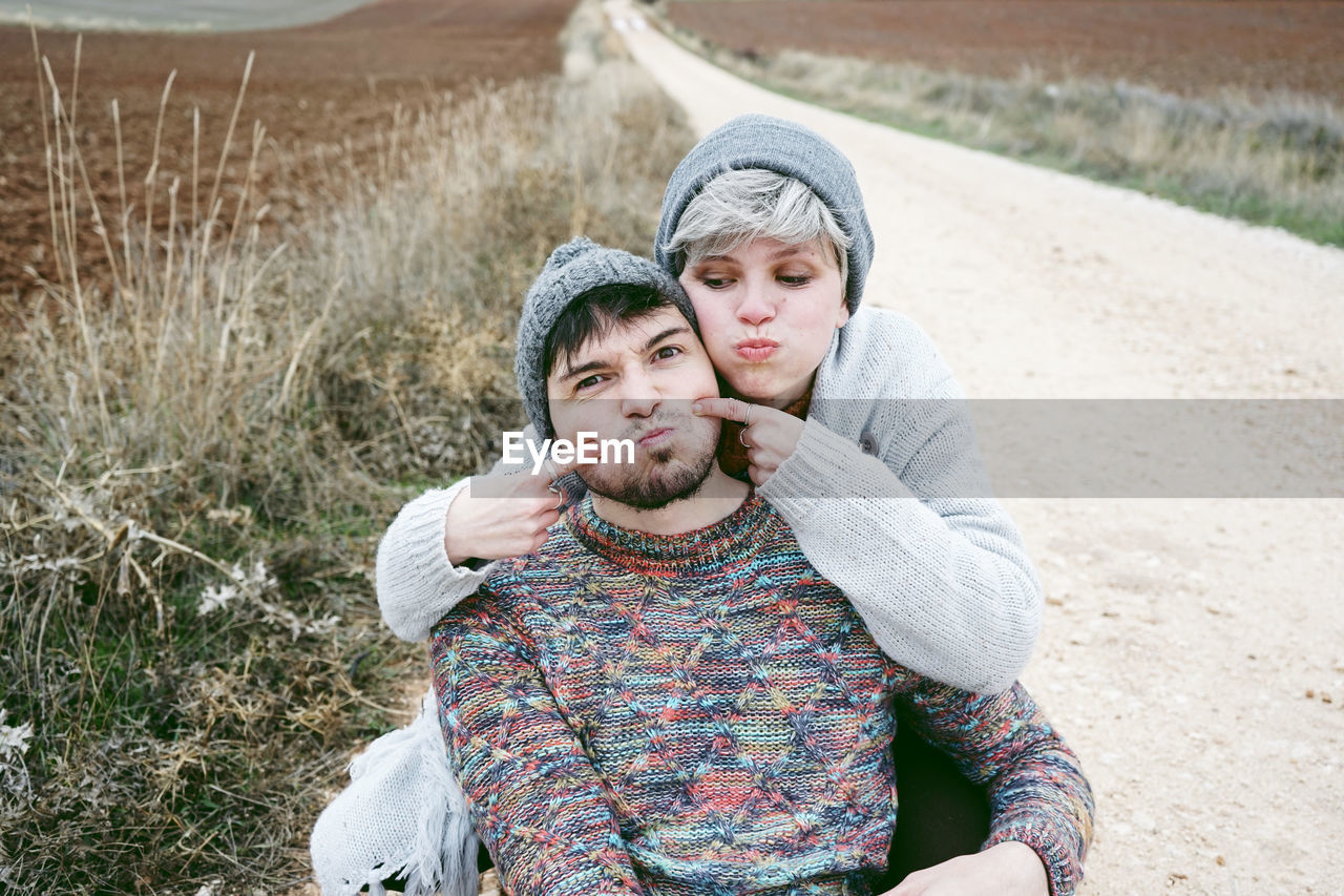 High angle view of happy couple standing on footpath