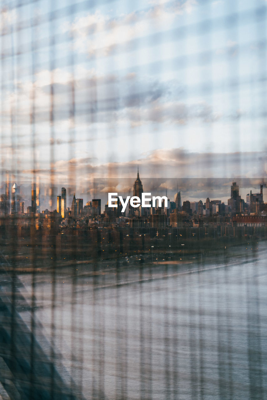 DIGITAL COMPOSITE IMAGE OF MODERN BUILDINGS IN CITY