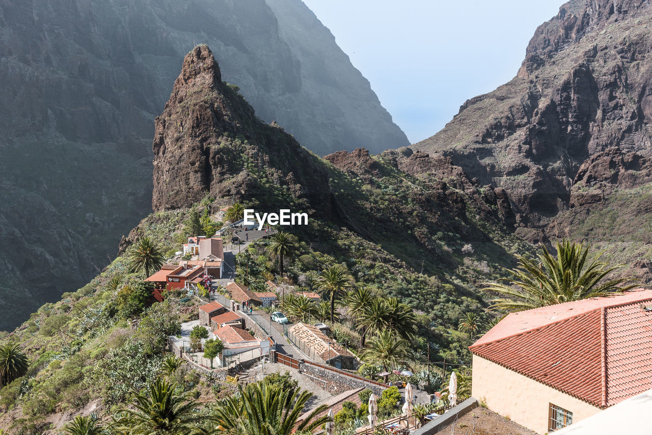 Panoramic view of buildings in town against sky