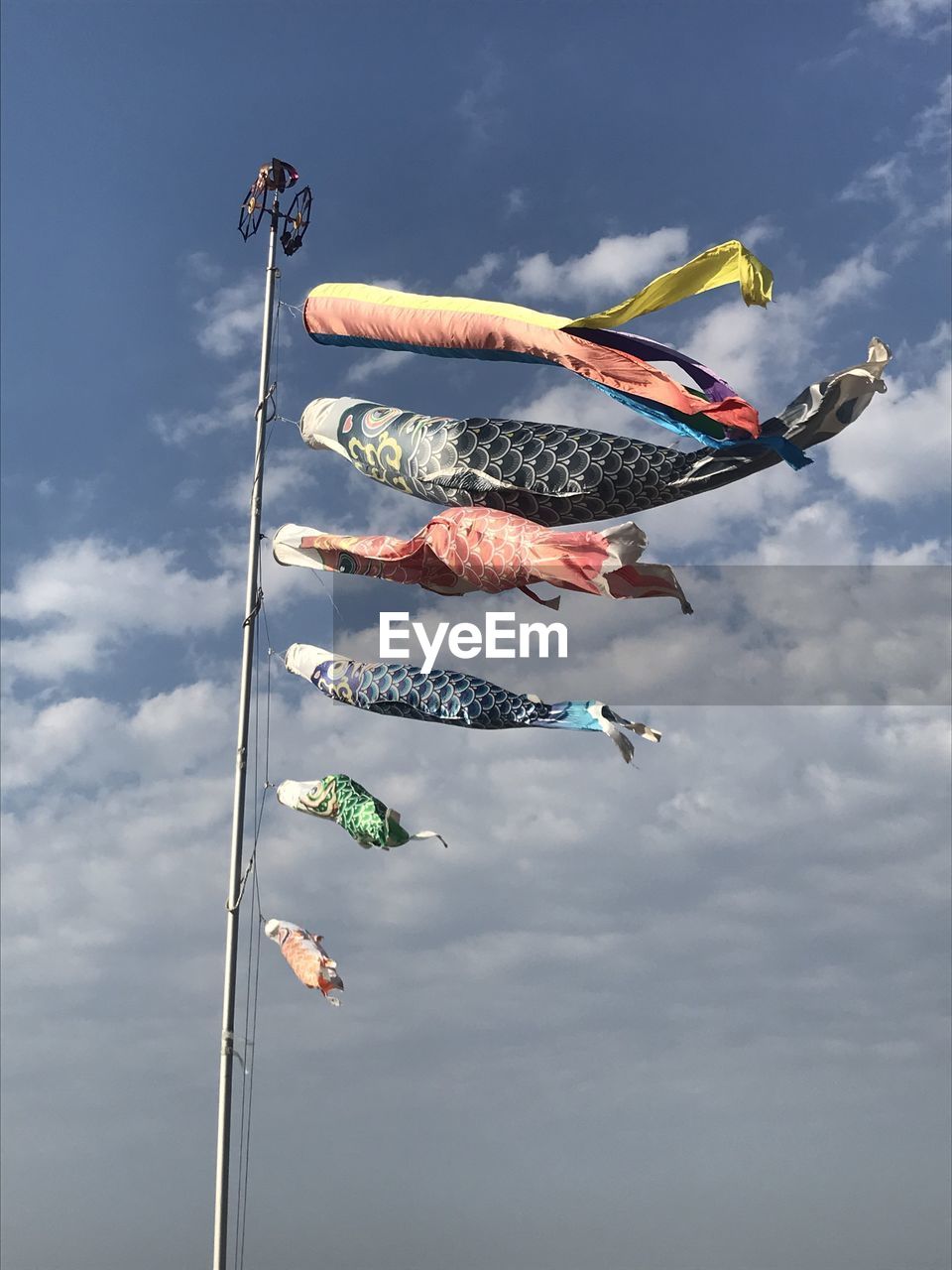 Low angle view of flags against sky