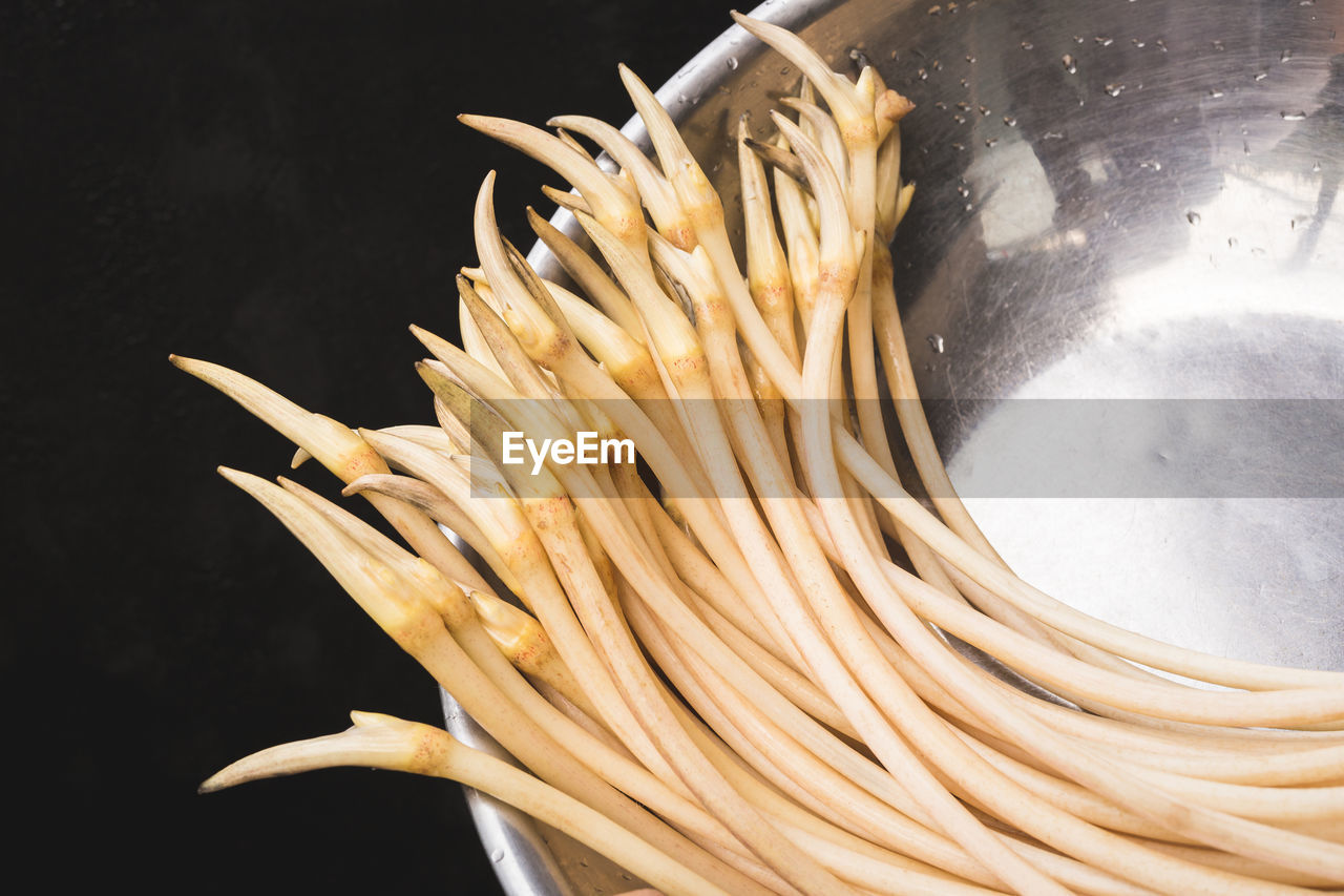 food, food and drink, pasta, italian food, freshness, healthy eating, wellbeing, indoors, kitchen utensil, raw food, household equipment, cuisine, close-up, no people, spaghetti, ingredient, dish, produce, still life, preparing food, vegetable, black background, kitchen, asian food