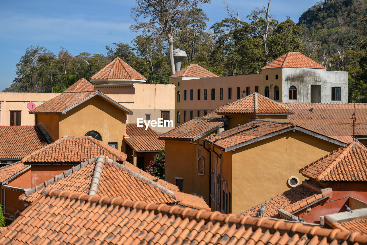 Residential buildings against sky in town