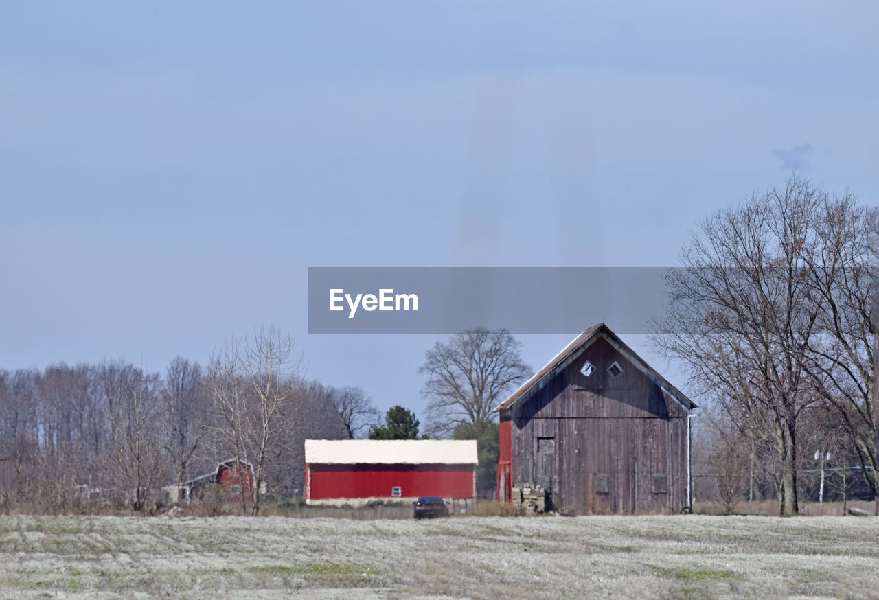 Barn on field against sky