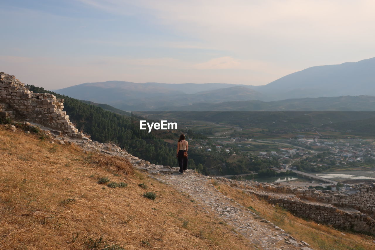 Woman standing on mountain against sky in berat, albania