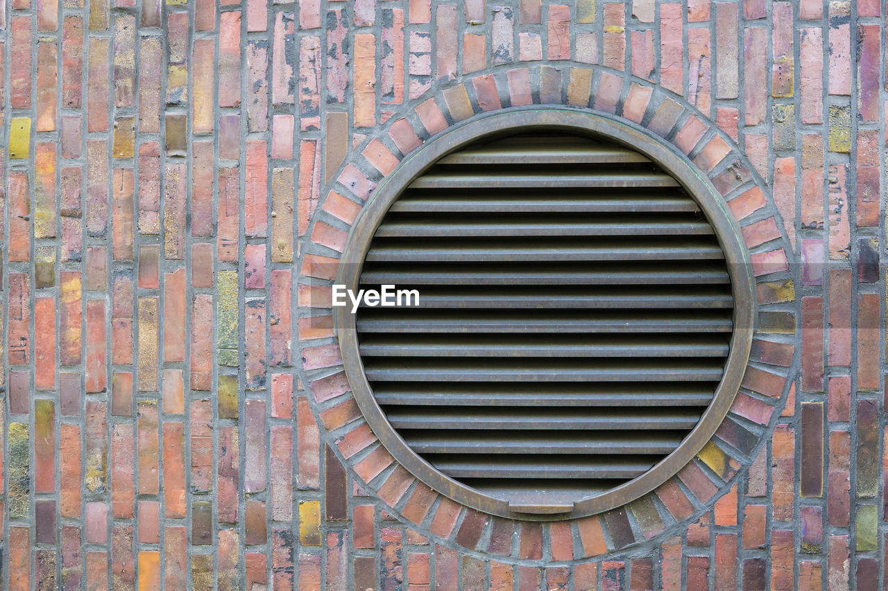 Circular ventilation exhaust vents in stone wall