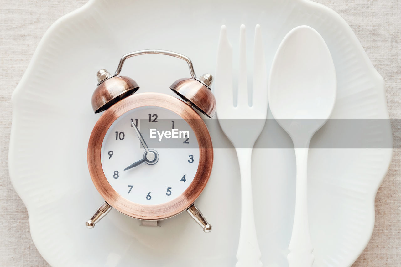 CLOSE-UP OF CLOCK ON TABLE