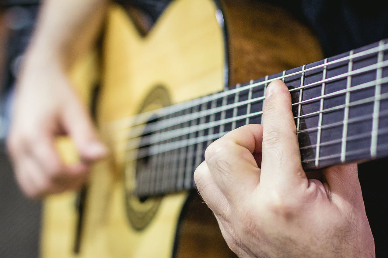 Cropped image of man playing acoustic guitar