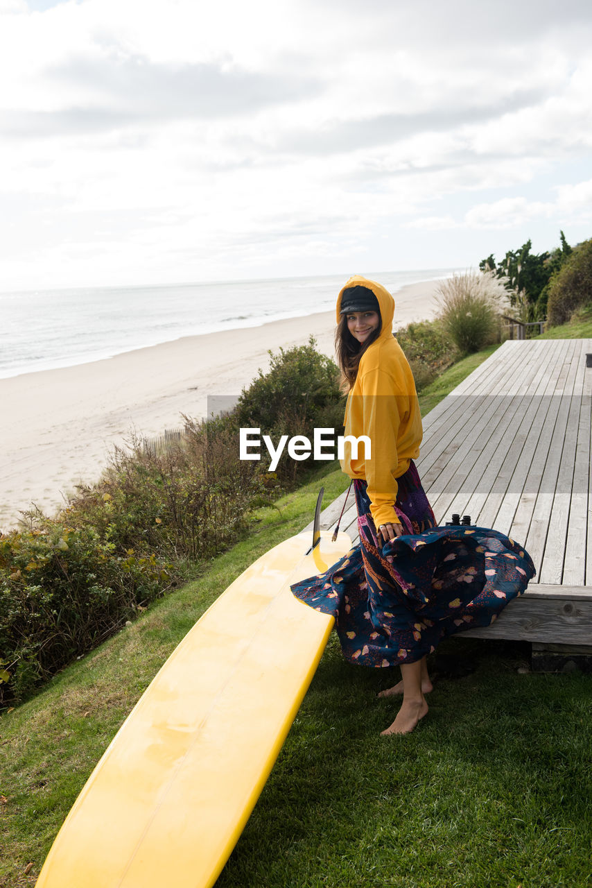 Stylish female surfer gets ready to surf