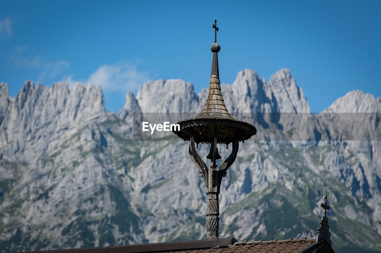 CROSS ON MOUNTAIN AGAINST SKY