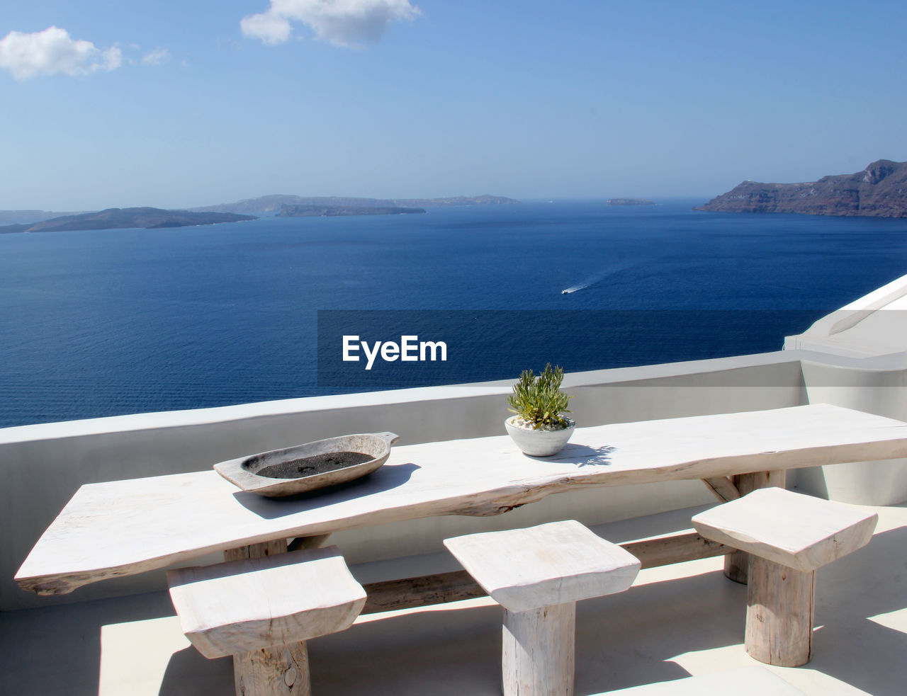 High angle view of table and seat on terrace against sea at santorini