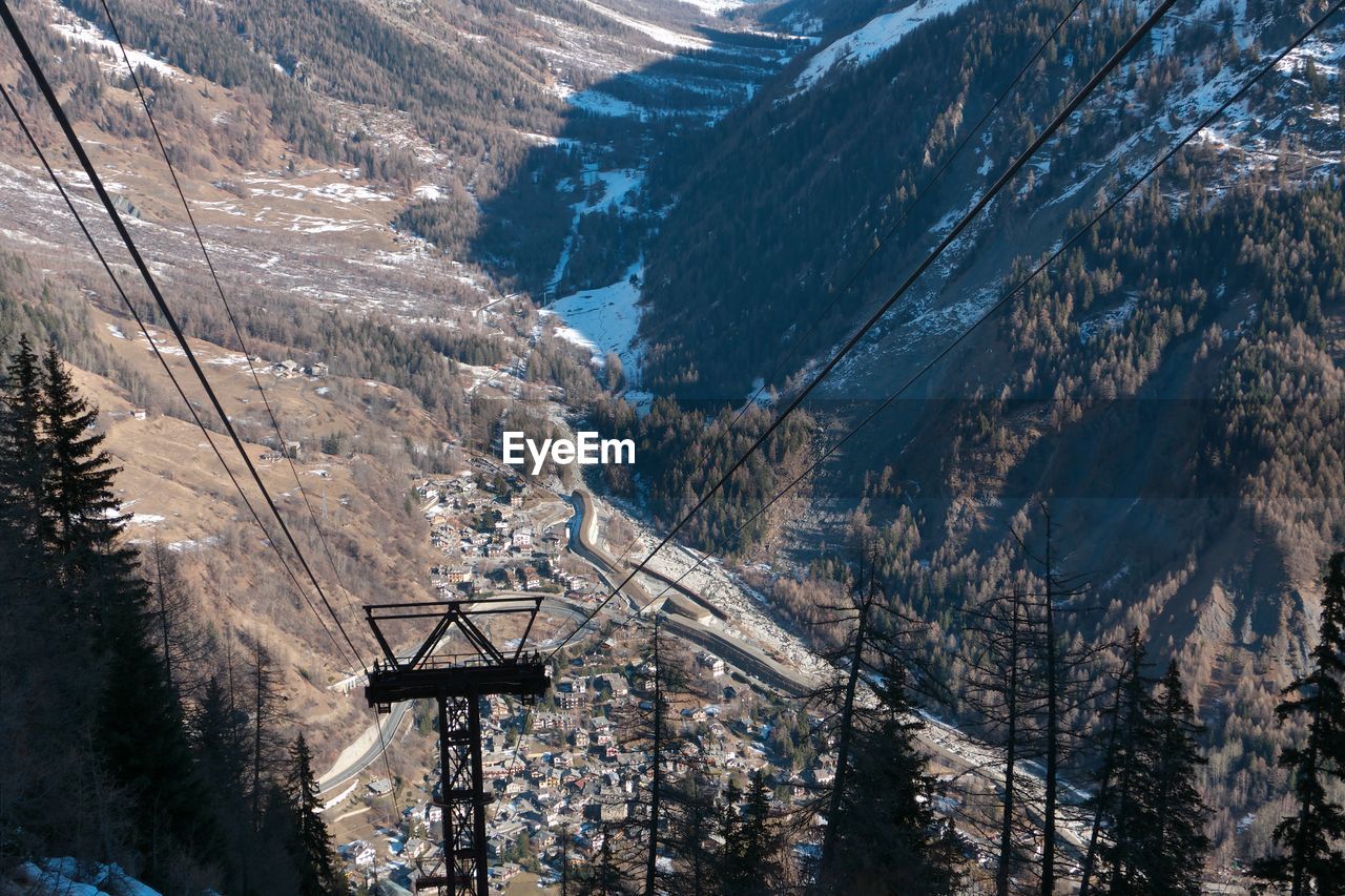 Overhead cable car on landscape against sky