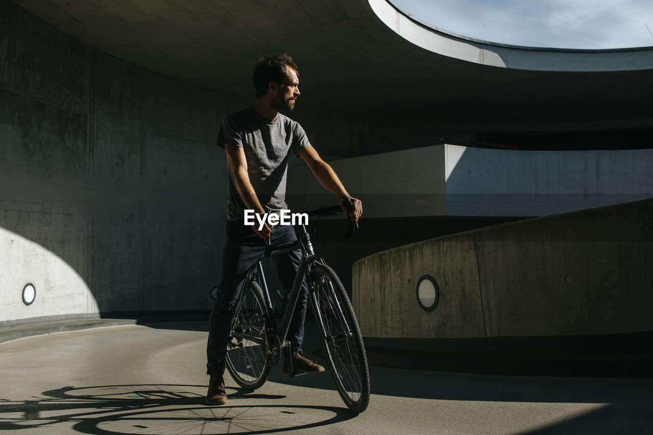 Man riding bicycle on bridge