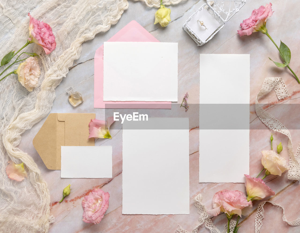 Wedding wedding stationery set with envelope laying on a marble table