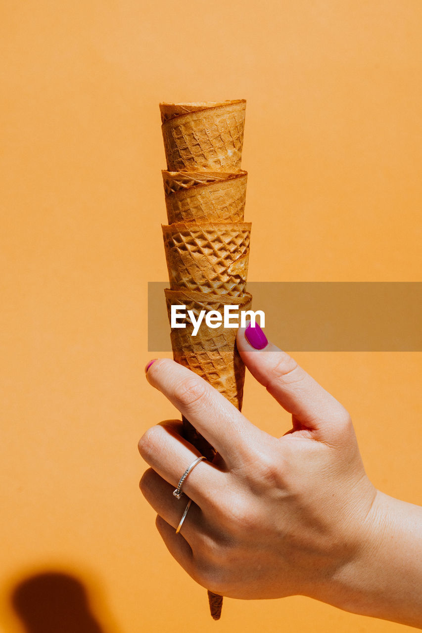 cropped hand of woman holding ice cream cone