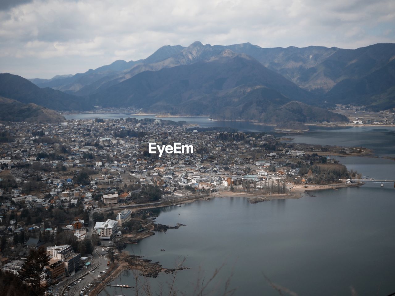 High angle view of townscape by sea against sky