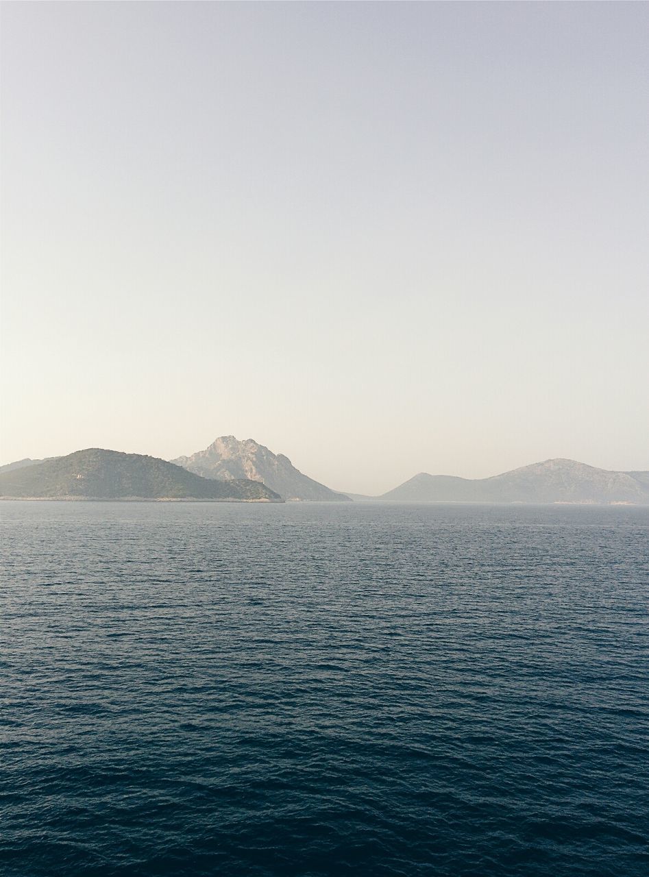 Calm and scenic beach against clear sky