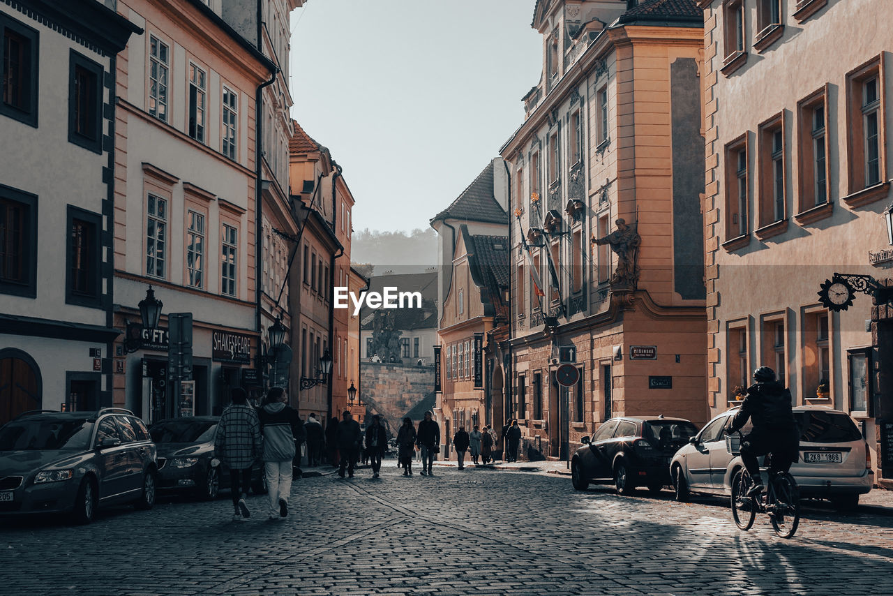 PEOPLE WALKING ON STREET IN CITY