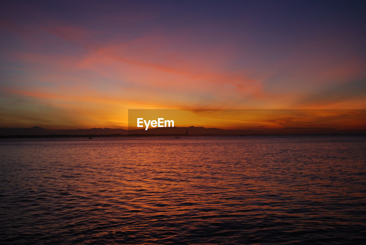 Scenic view of sea against romantic sky during sunset