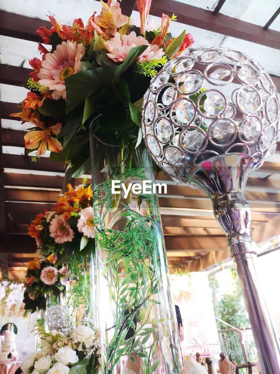 CLOSE-UP OF FLOWER POT HANGING ON TABLE IN ROOM