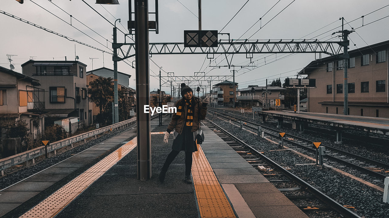 TRAIN ON RAILROAD STATION PLATFORM