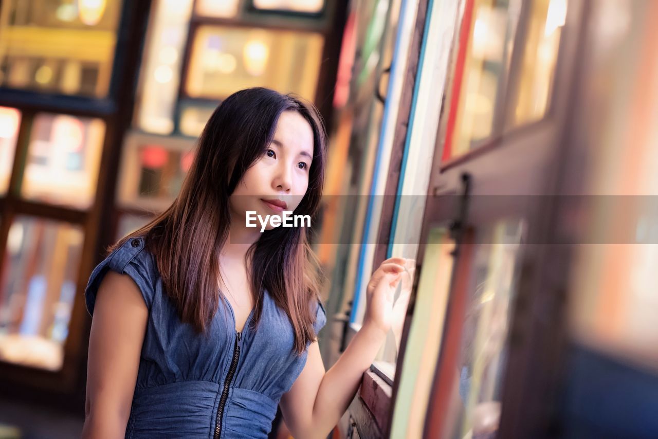 Young woman looking towards window in restaurant 