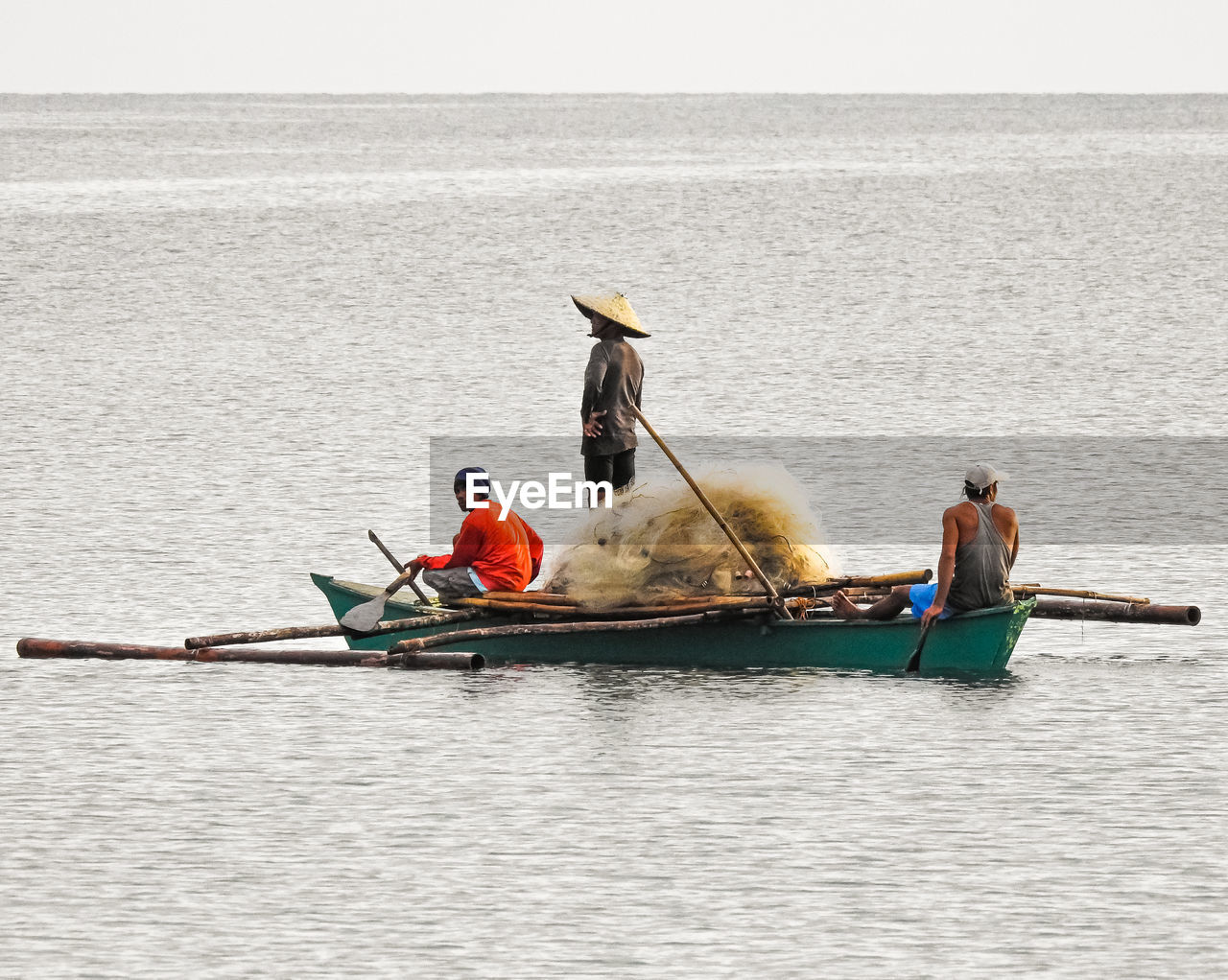 PEOPLE SITTING ON BOAT IN SEA