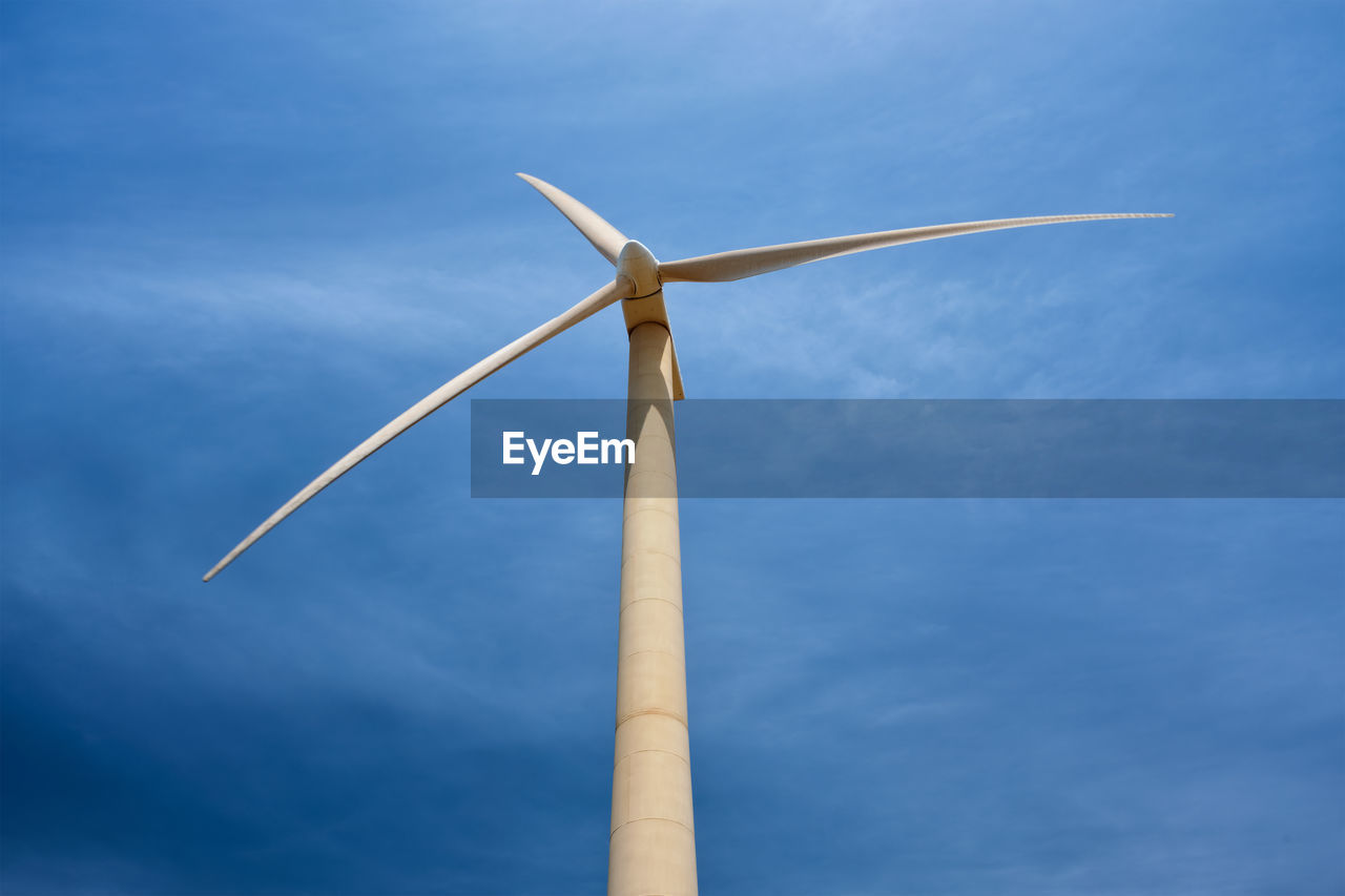 low angle view of wind turbine against blue sky