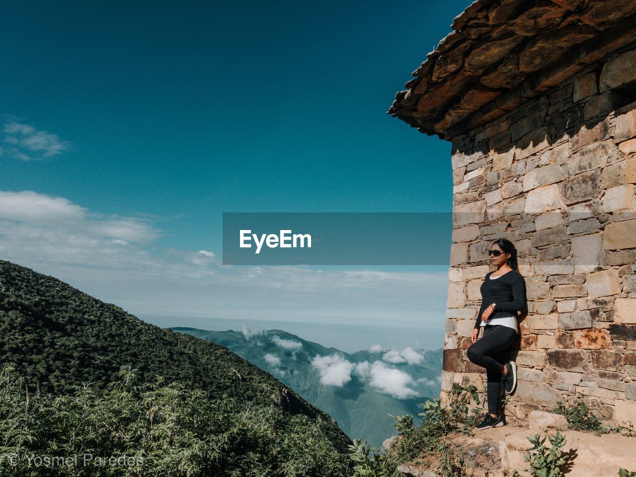 WOMAN STANDING ON MOUNTAIN