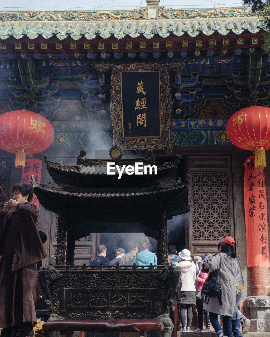 PEOPLE IN TEMPLE OUTSIDE BUILDING AT ENTRANCE OF CATHEDRAL