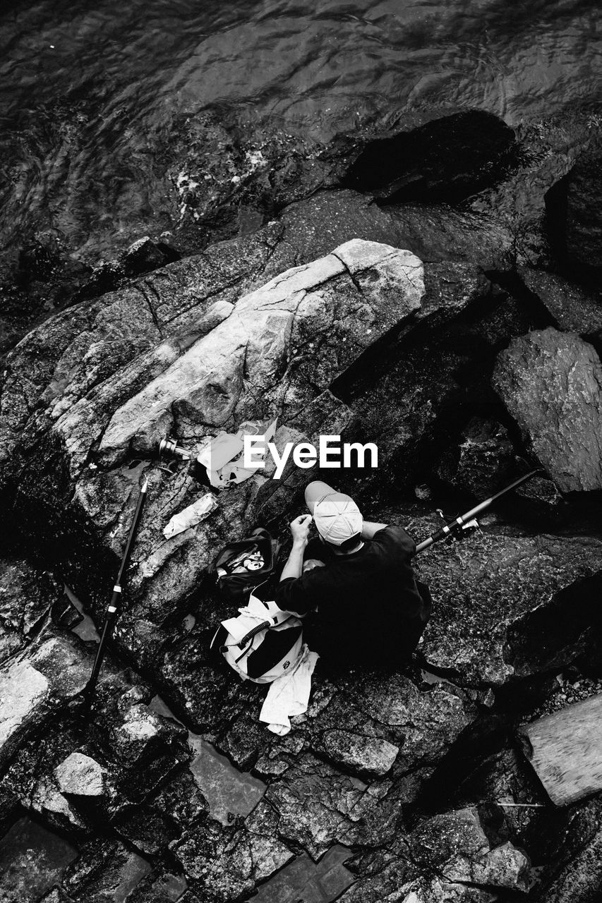 High angle view of man working on rock