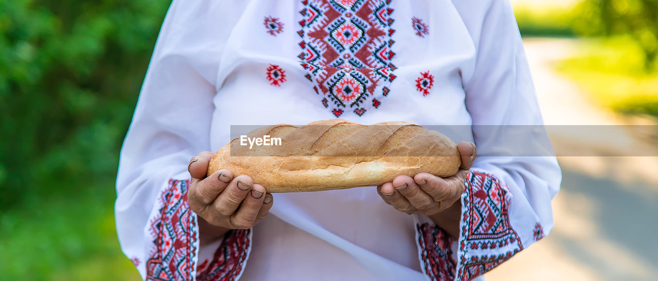 Midsection of woman holding bread