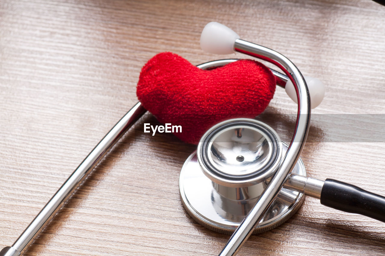 High angle view of heart shape on table with stethescope 