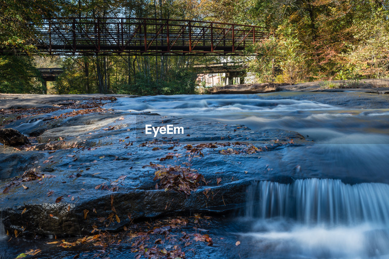 Scenic view of waterfall in forest during winter