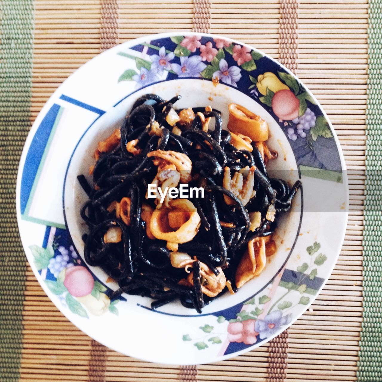 Directly above shot of black pasta served in plate on table