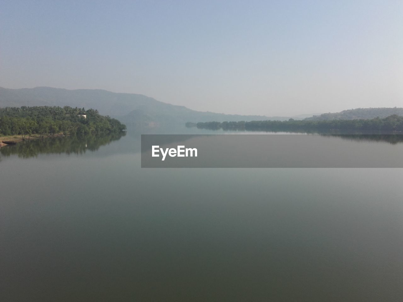 SCENIC VIEW OF LAKE WITH MOUNTAINS IN BACKGROUND