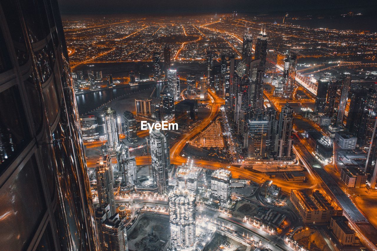 High angle view of illuminated buildings in city at night