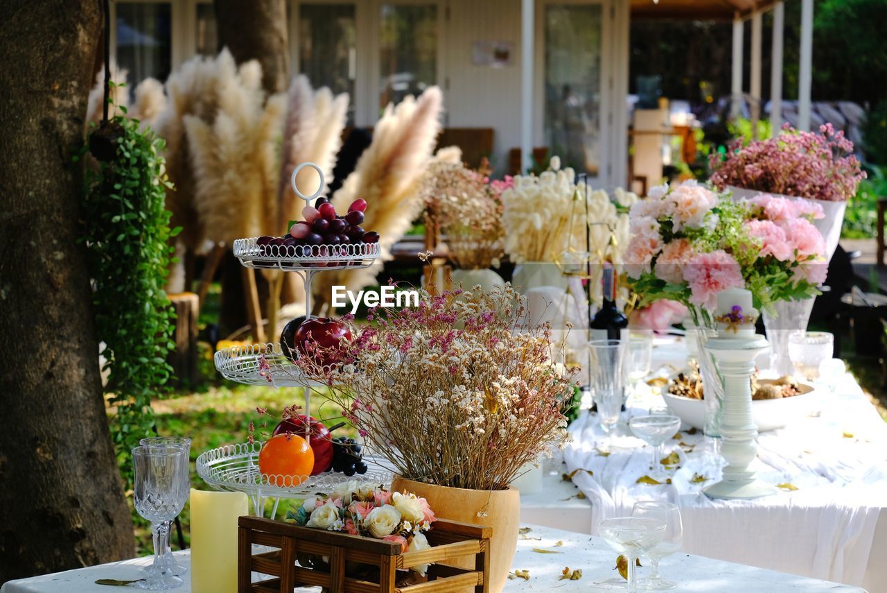 FLOWER POT ON TABLE AGAINST PLANTS