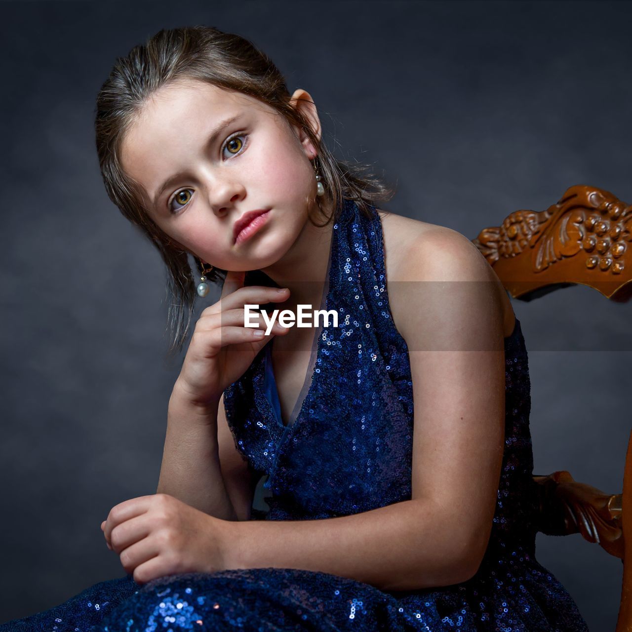 portrait of young woman sitting on sofa