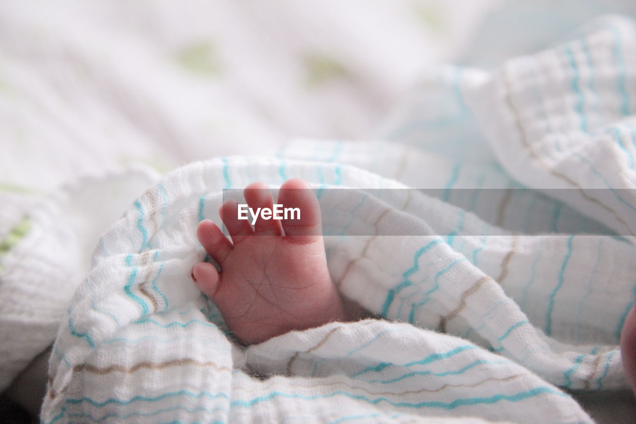 Foot of baby sleeping in bed