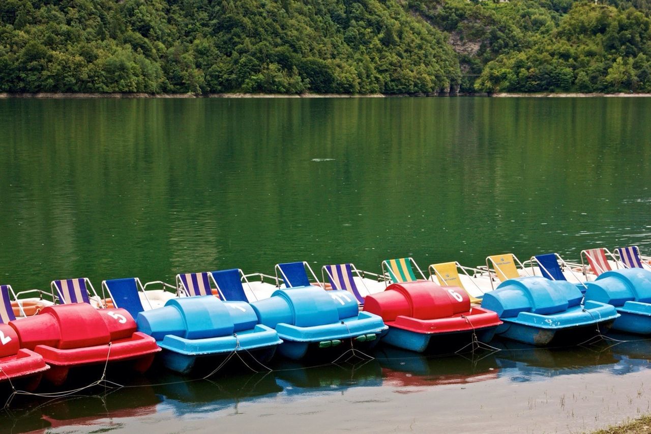 Empty pedal boats in calm lake