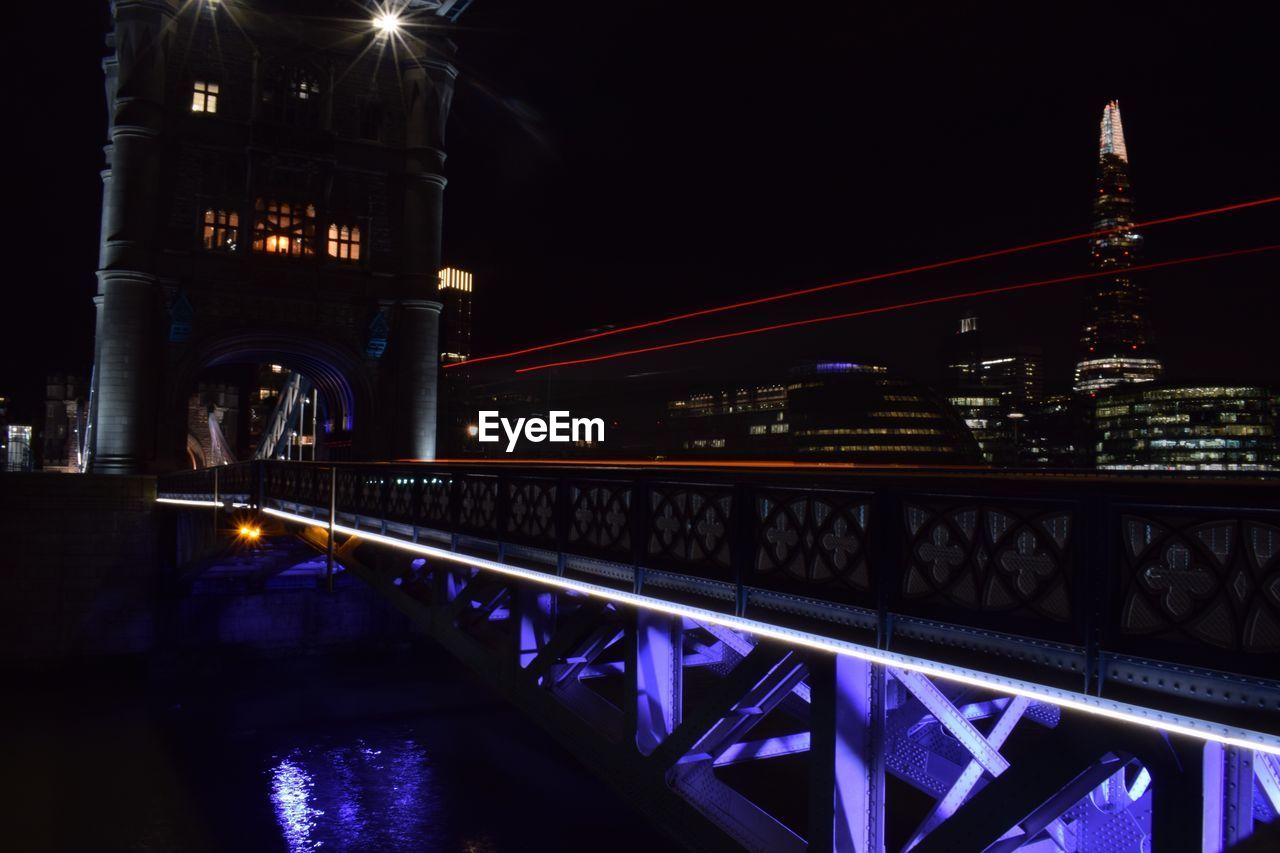 ILLUMINATED SUSPENSION BRIDGE AT NIGHT