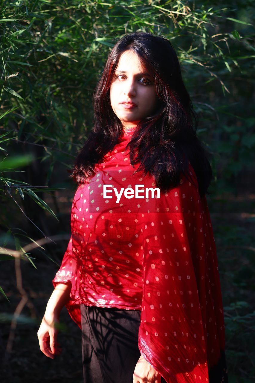 Portrait of a beautiful young woman standing outdoors