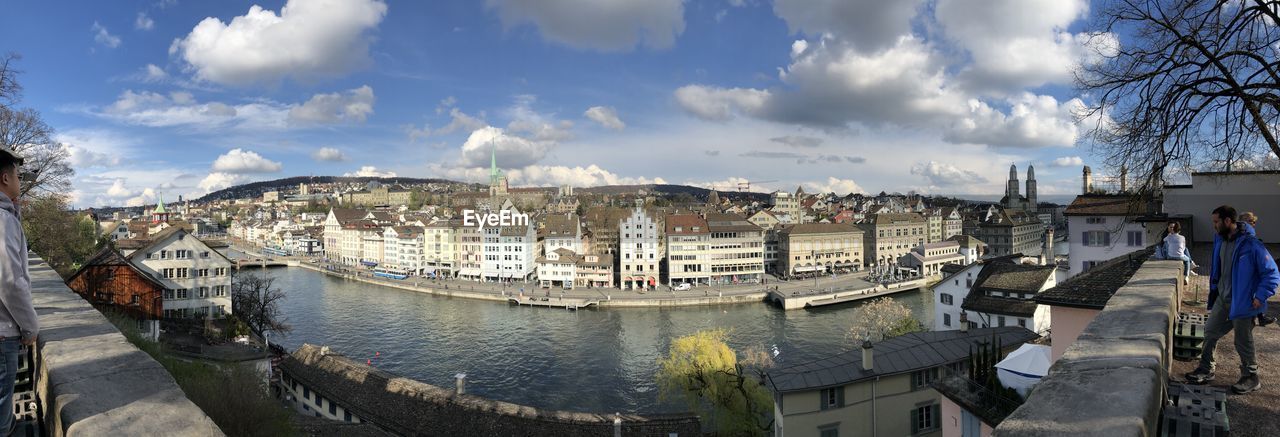PANORAMIC VIEW OF RIVER BY BUILDINGS AGAINST SKY