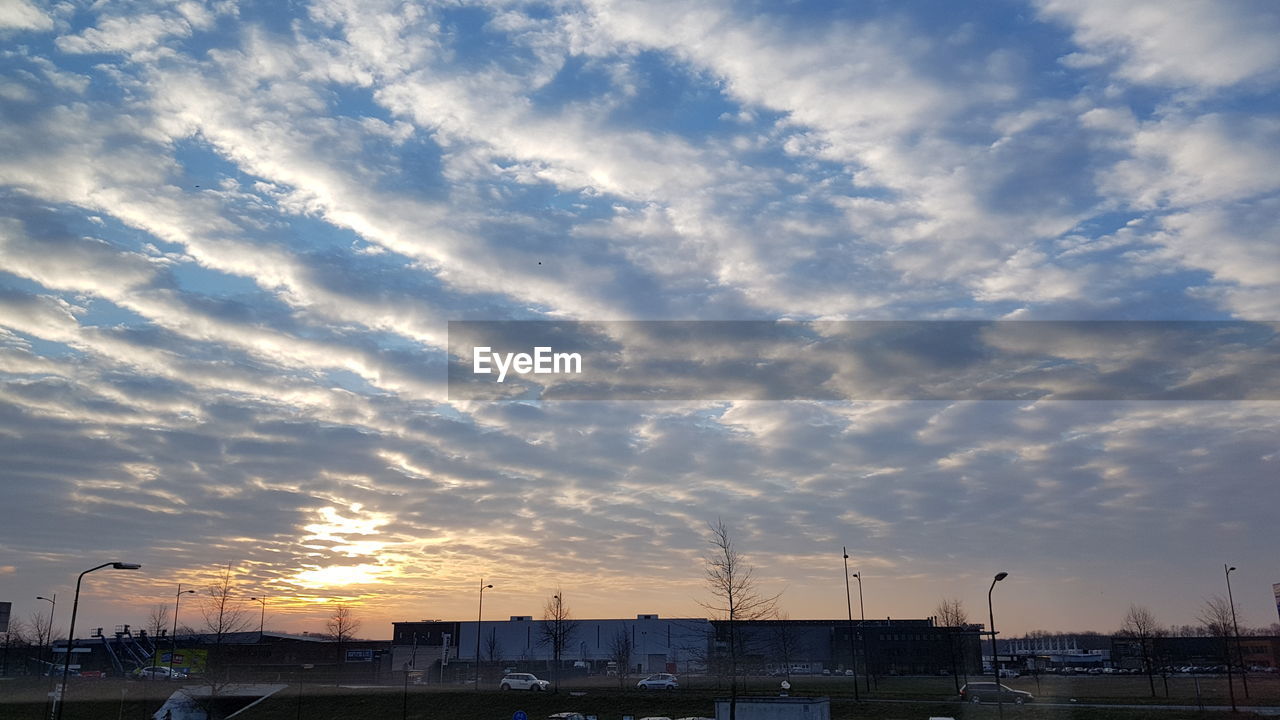 VIEW OF CITYSCAPE AGAINST DRAMATIC SKY