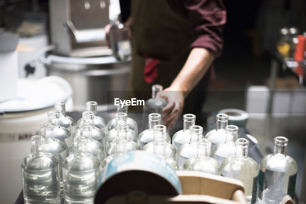 Bottles of liquor being filled at a distillery.