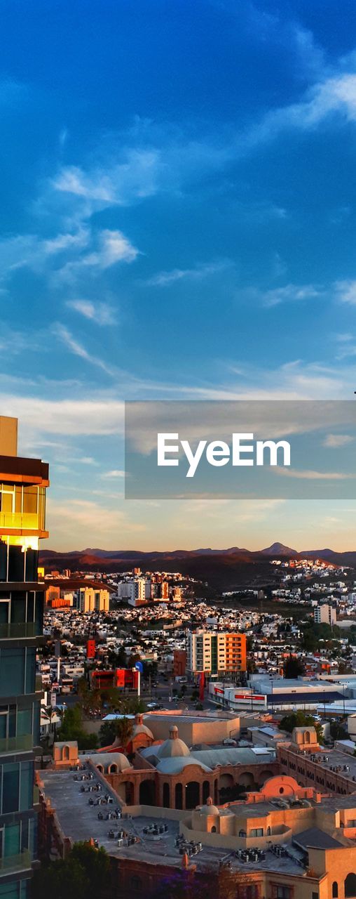 High angle view of illuminated buildings against sky during sunset