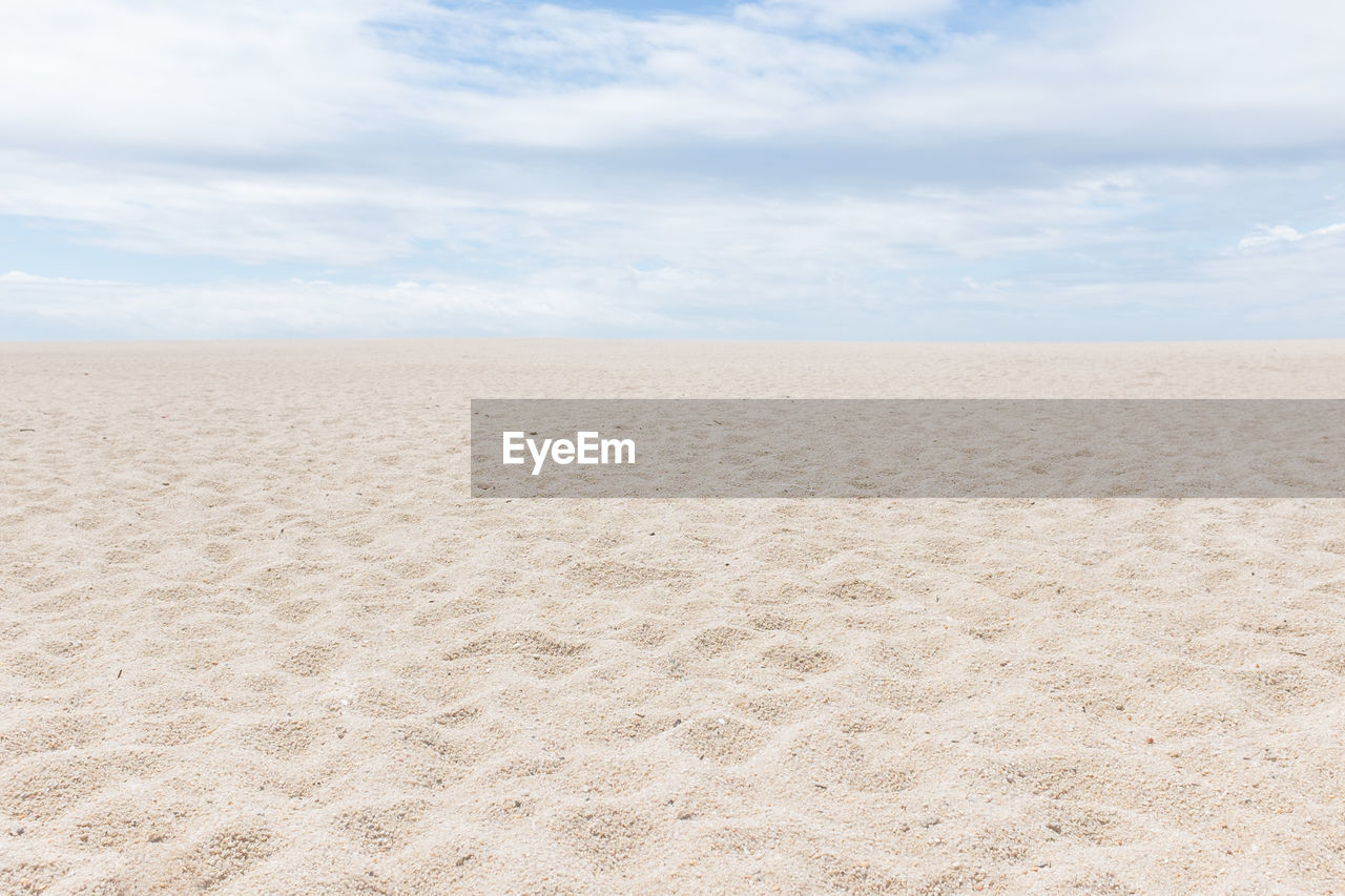 Scenic view of sand dunes against sky