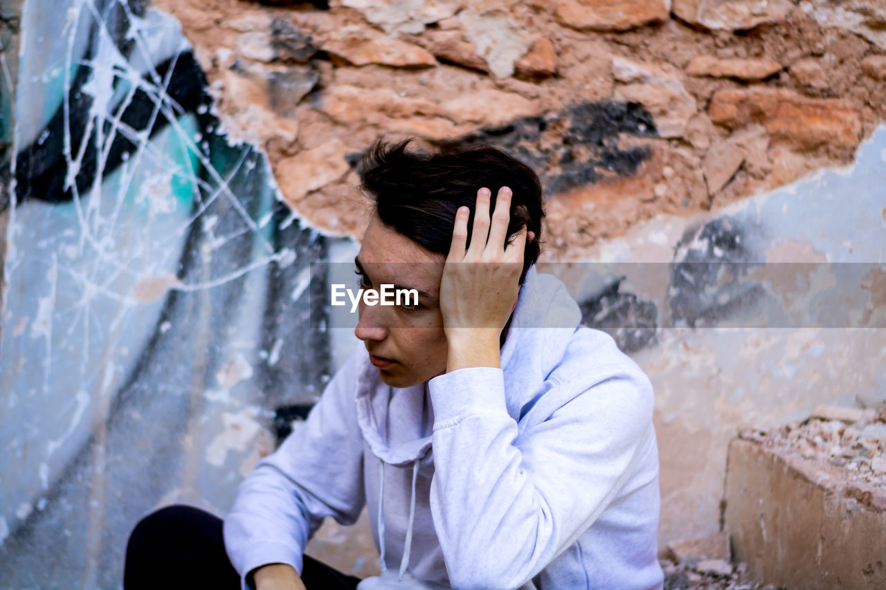 Thoughtful man sitting outdoors