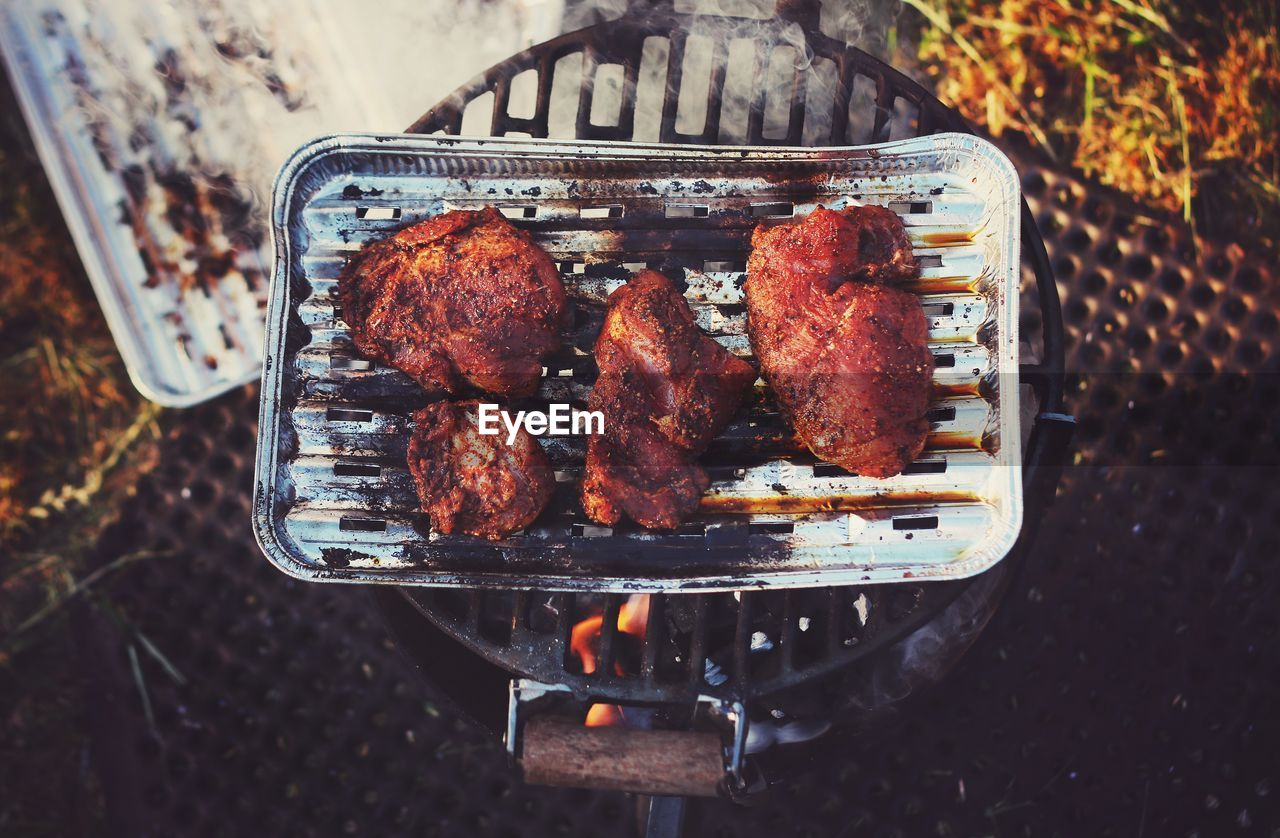 High angle view of meat on barbecue grill